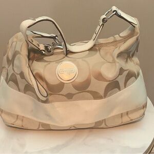 Tan Coach monogram purse.